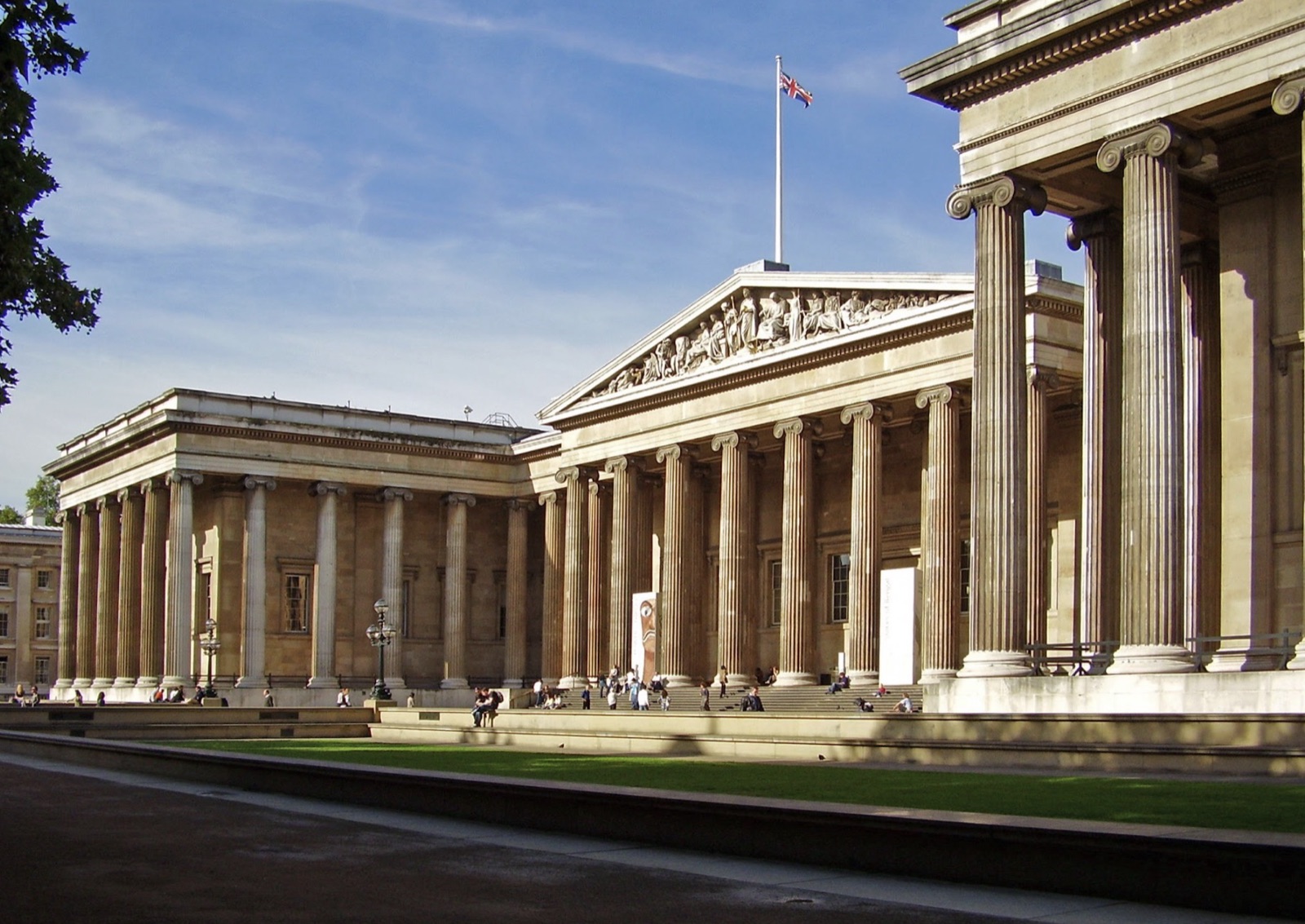 The columned front of a classical museum building on a clear evening